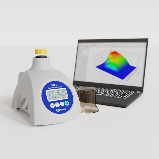 Biosan RTS-1C personal bioreactor with computer in backgound showing growth chart